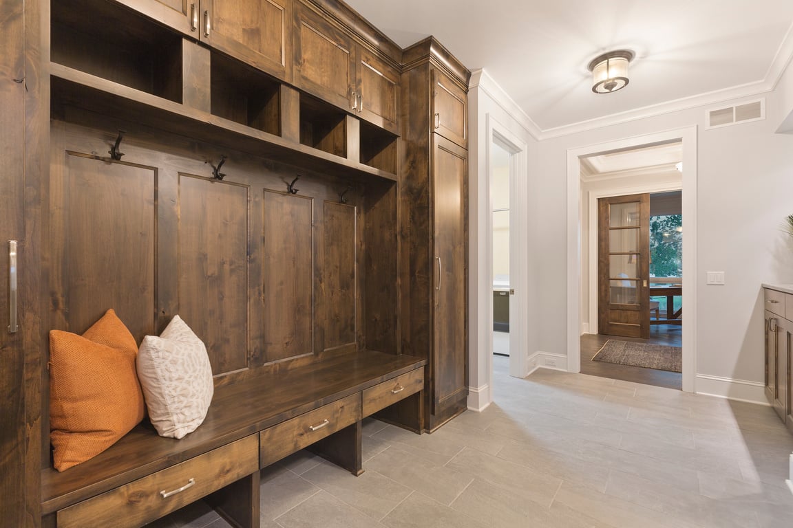 Natural dark wood in mudroom of new home